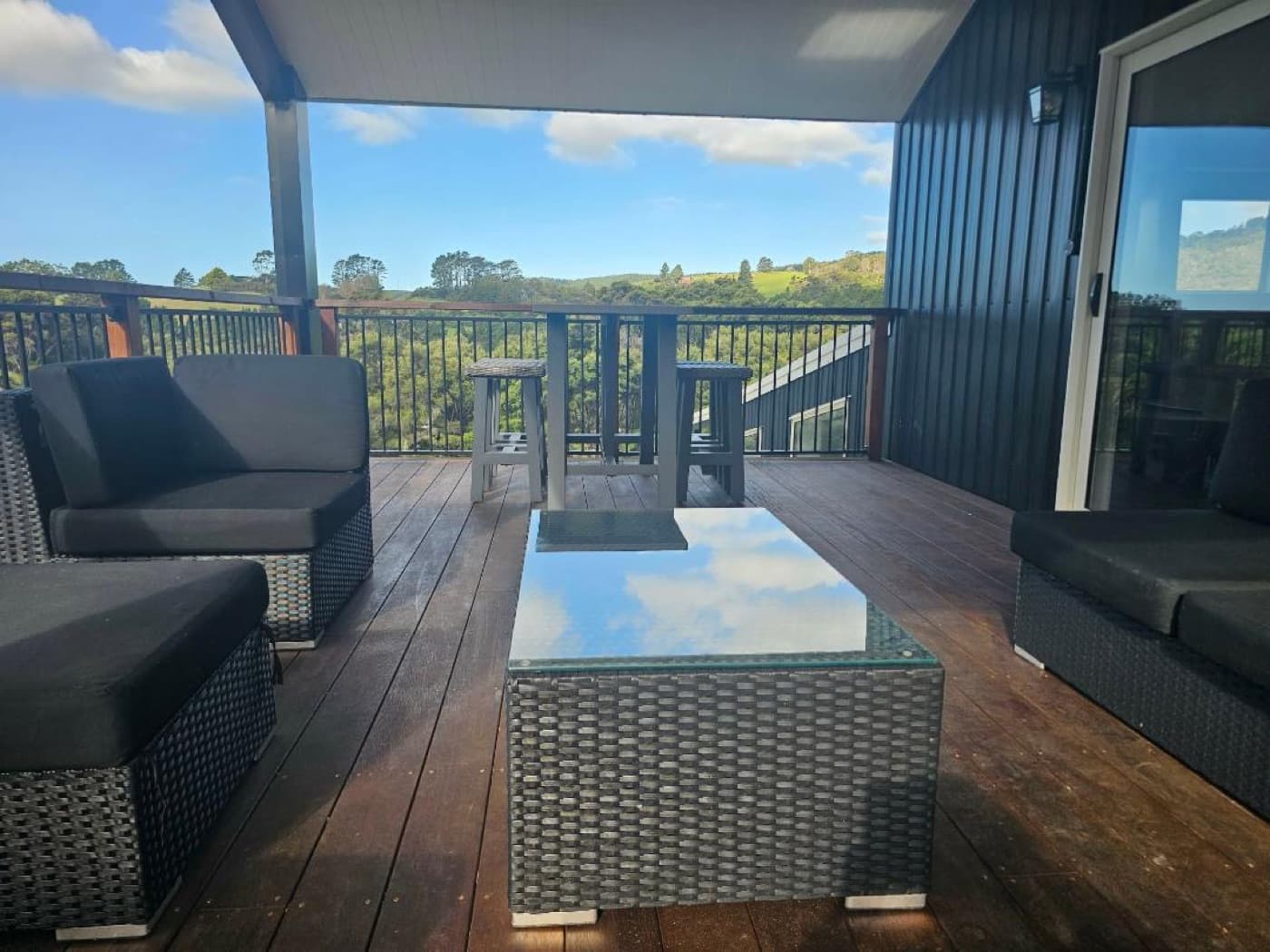 The covered upper deck with lounge seating and valley views