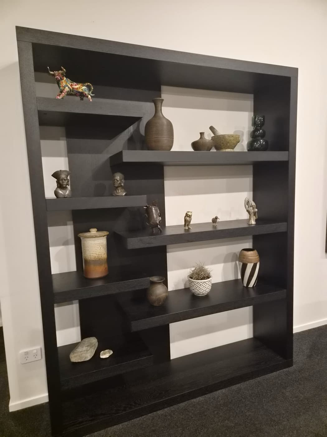 Collected ornaments on the black display shelf