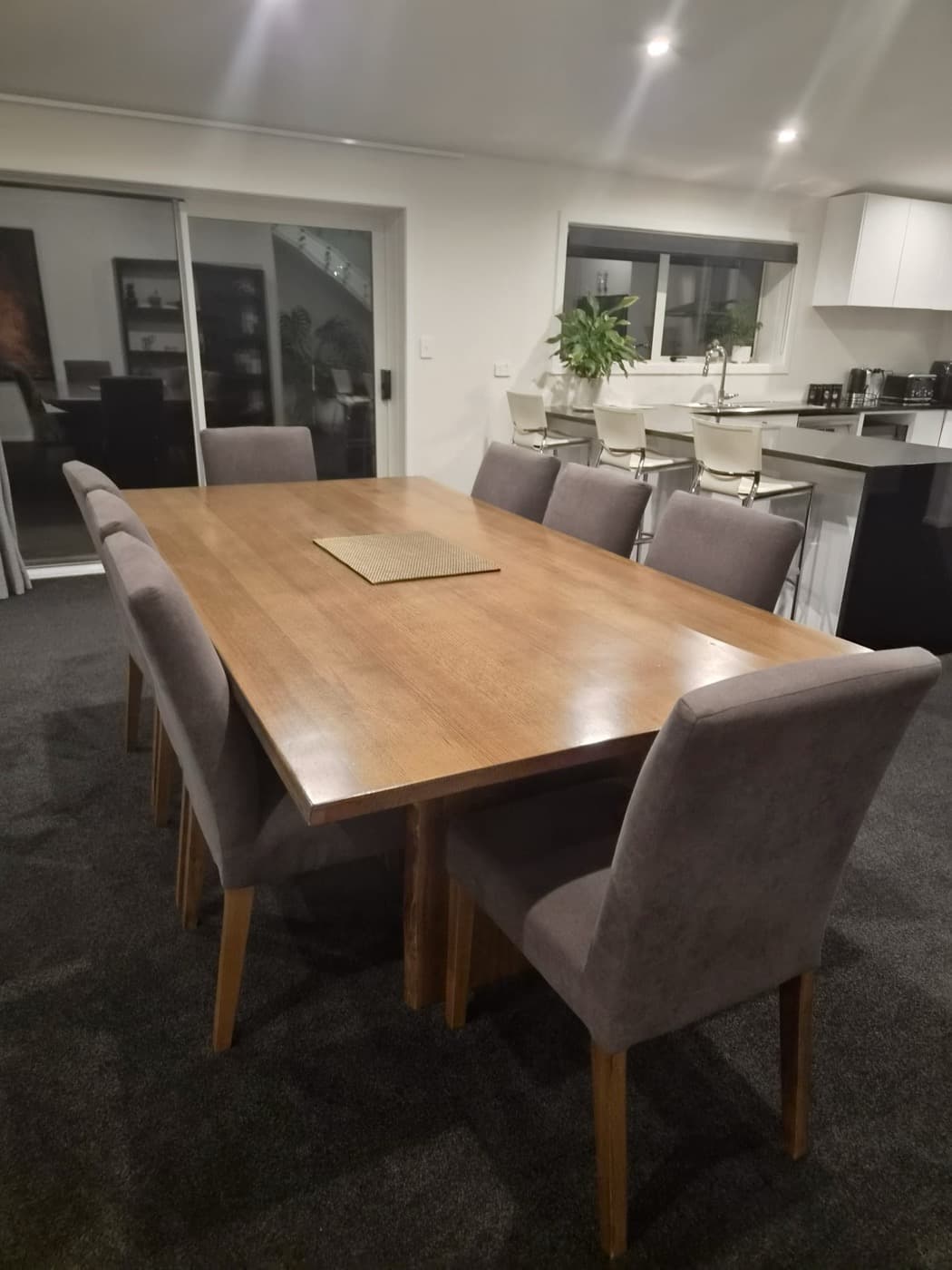 The dining table seats up to eight, open to the kitchen