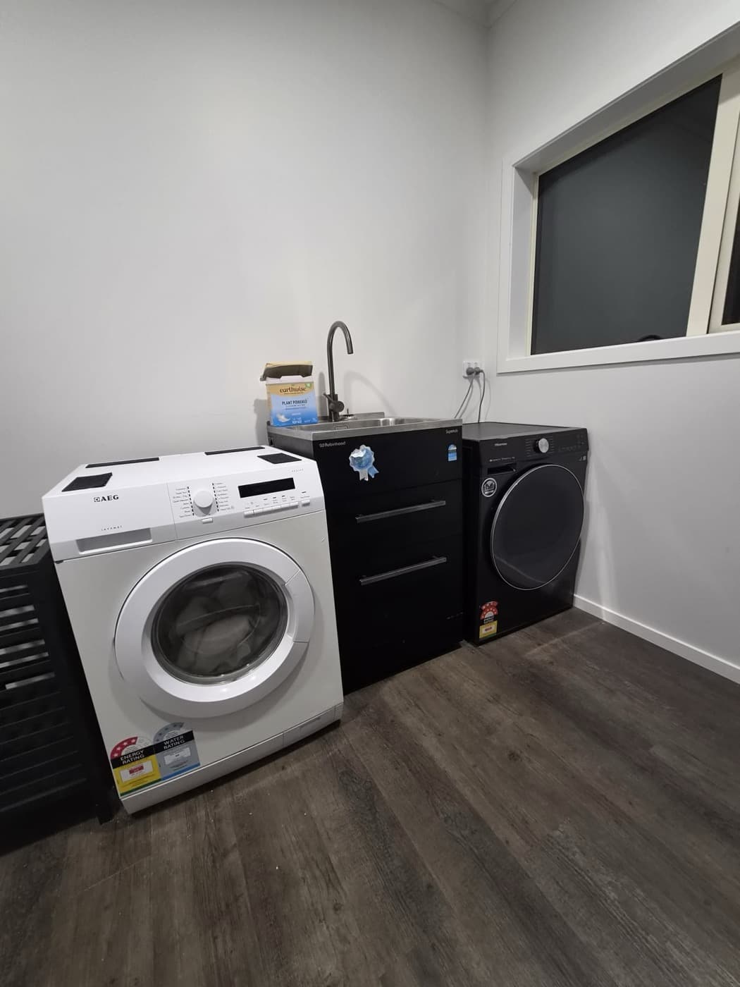 The laundry with washer, sink and dryer