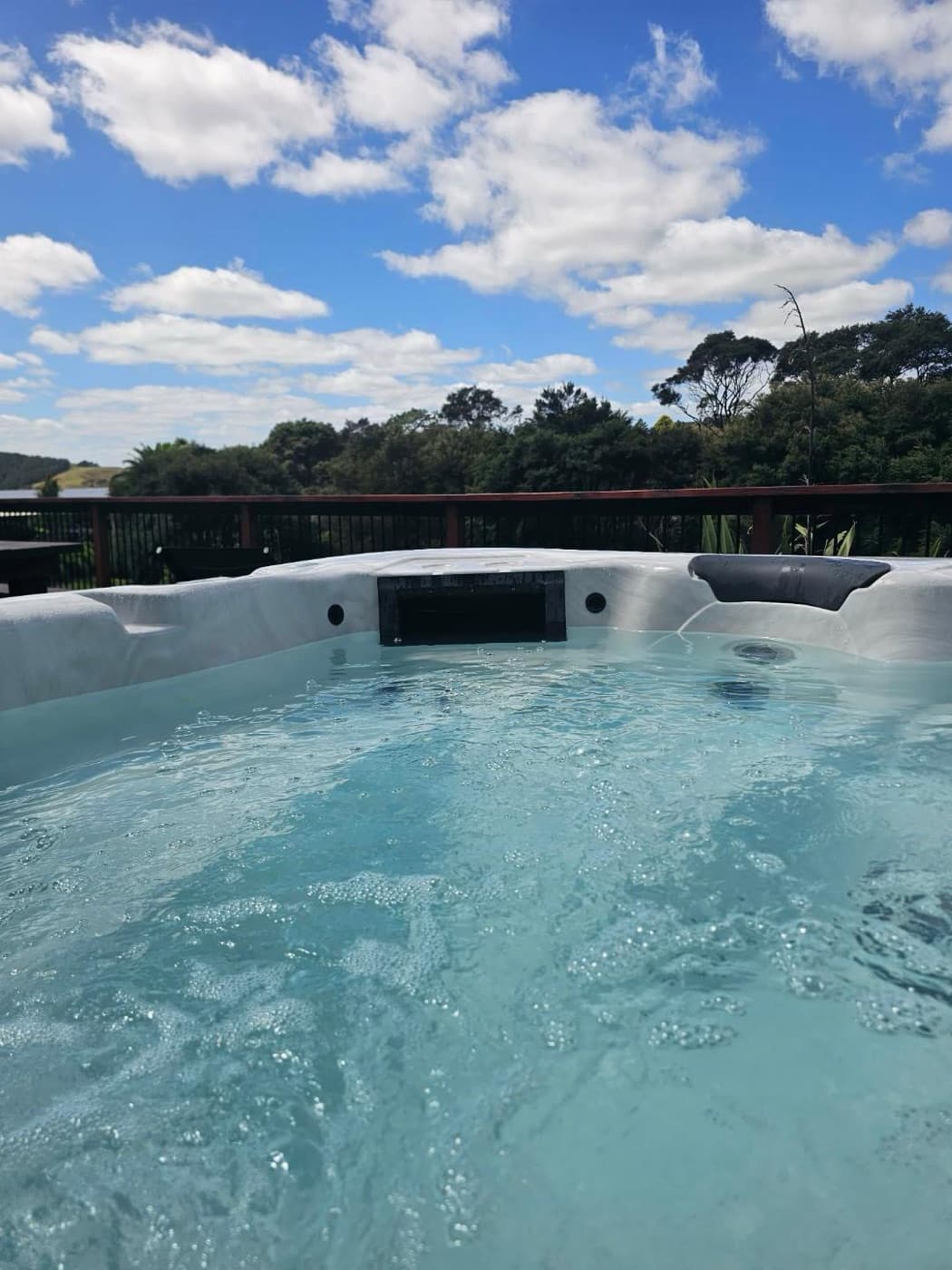 The spa pool bubbling, with the valley beyond