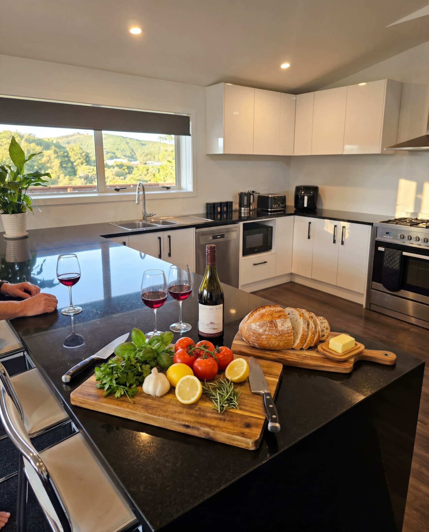Fresh bread, cheese, produce and wine on the kitchen island, valley beyond